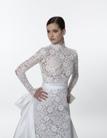 Closeup of the front of the Valentini Spose V1270 long sleeve lace wedding dress with a high neckline and long sleeves