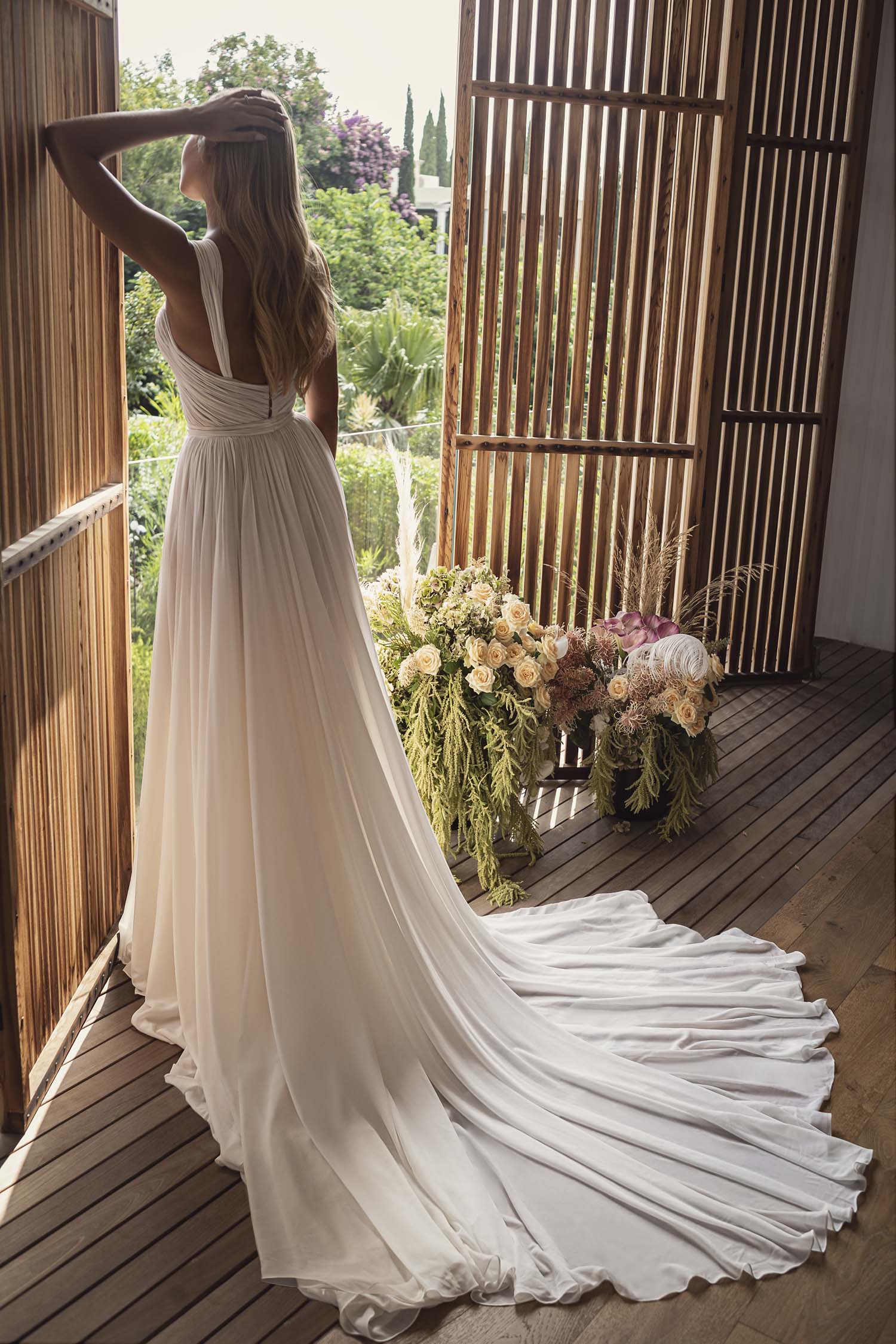 lee petra grebenau reef silk chiffon a line wedding dress with straps on a bride showing the back of the skirt at dimitra's bridal chicago