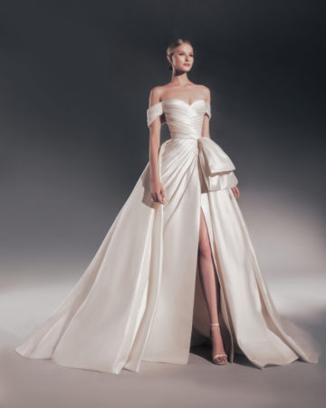 Zuhair Murad fall 2022 katya wedding dress at dimitras bridal chicago featuring a pleated mikado off the shoulder wedding gown with high slit, bow detail, and matching overskirt