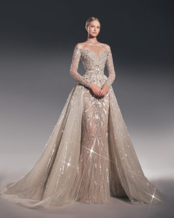 Zuhair Murad fall 2022 katya wedding dress at dimitras bridal in chicago featuring a fully beaded tulle long sleeve sheath bridal gown with off the shoulder sweetheart neckline and a matching beaded tulle overskirt